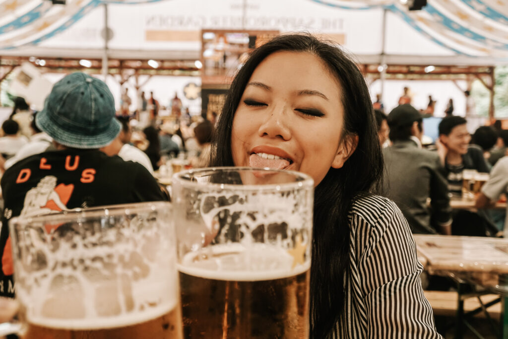 a girl drinking sapporo beers in hokkaido japan in a beer tent