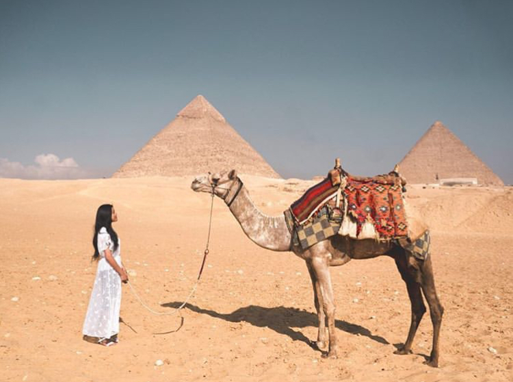 Me alone with a camel in front of the pyramids of Giza in Egypt
