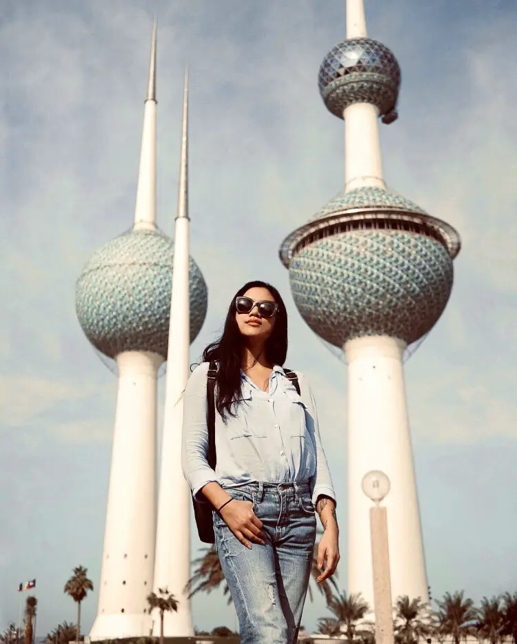 A woman posing in front of Kuwait Towers in Kuwait City 