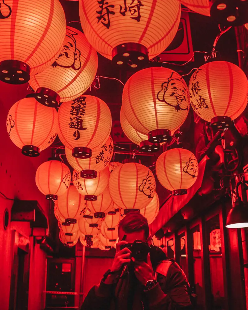 red lanterns in a dark alley and a photographer