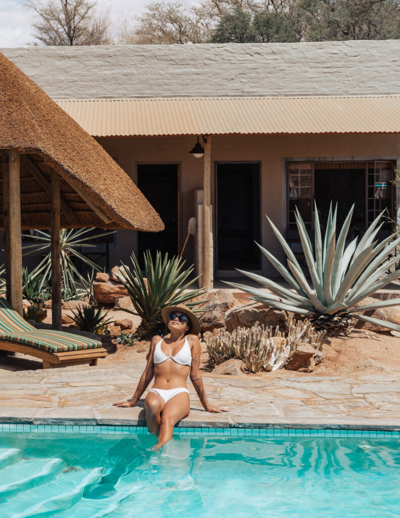girl sitting next to a swimming pool in Namibia