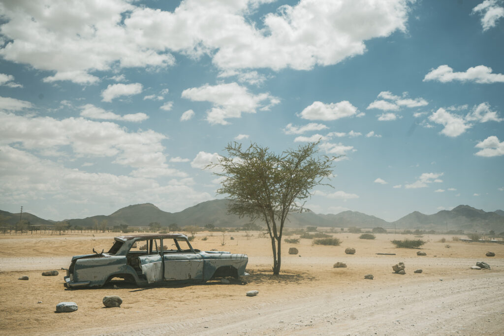 an abandoned car in the middle of the desert in Namibia