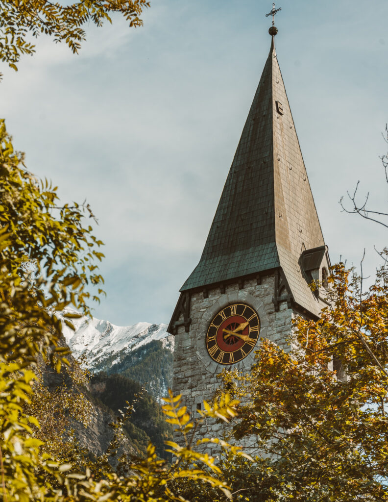 A church tower with the mountains in the background in Liechtenstein