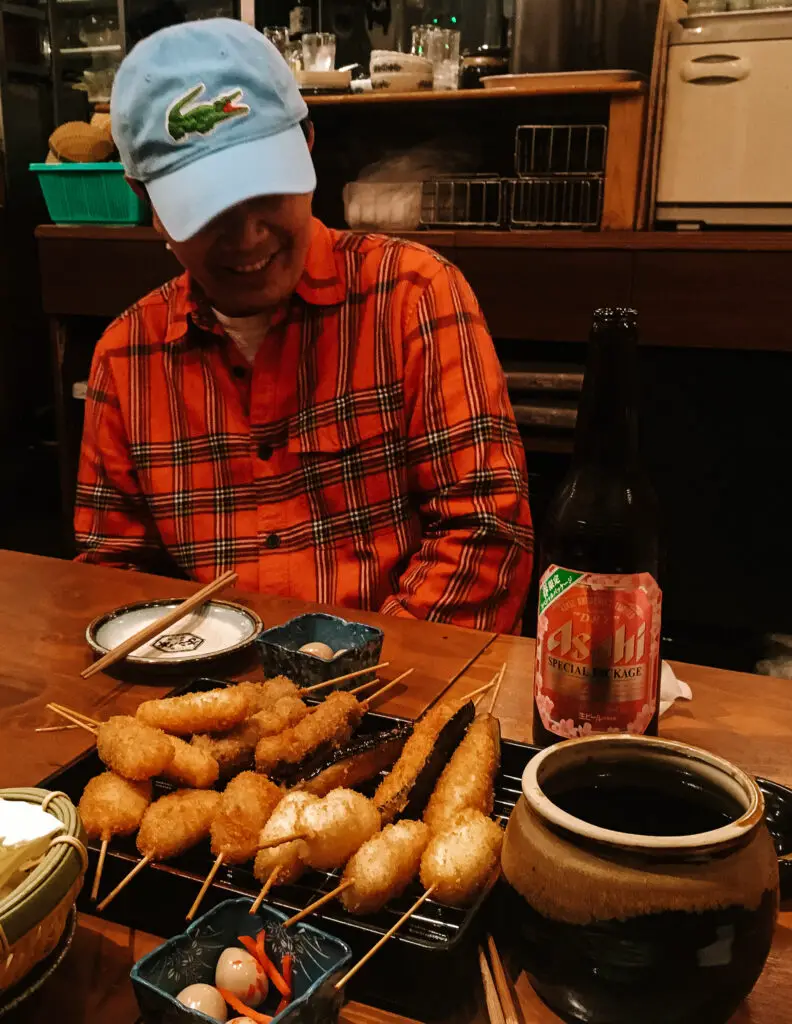 kushikatsu and japanese beer and a man in japan