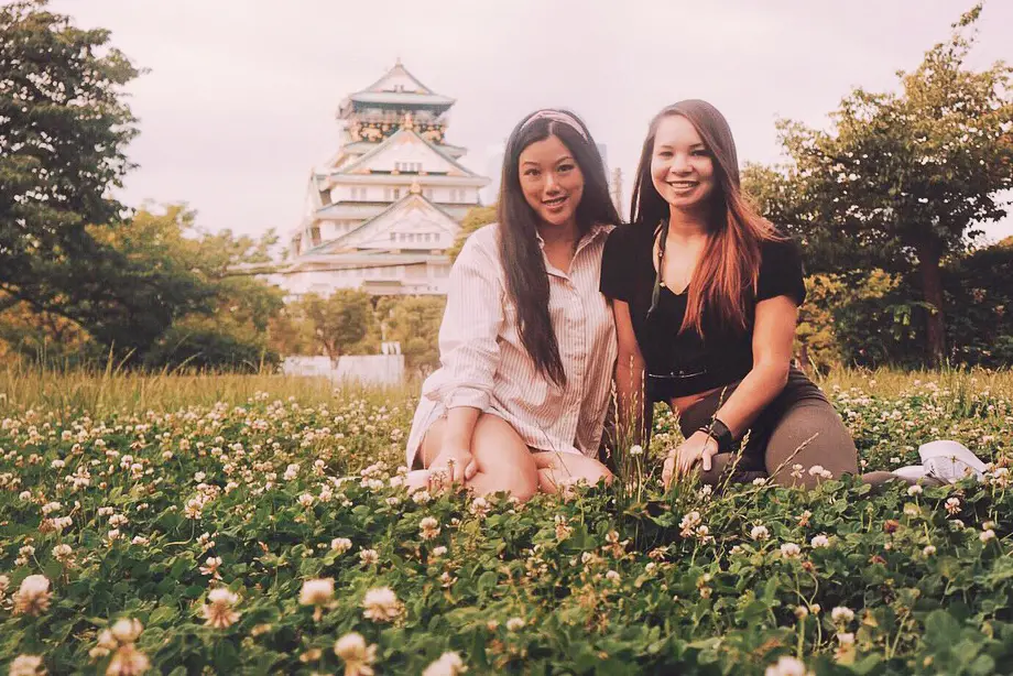 two girls on the grass at osaka castle park