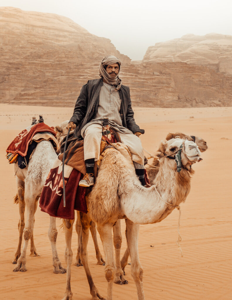 a bedouin man and his camels in wadi rum in jordan