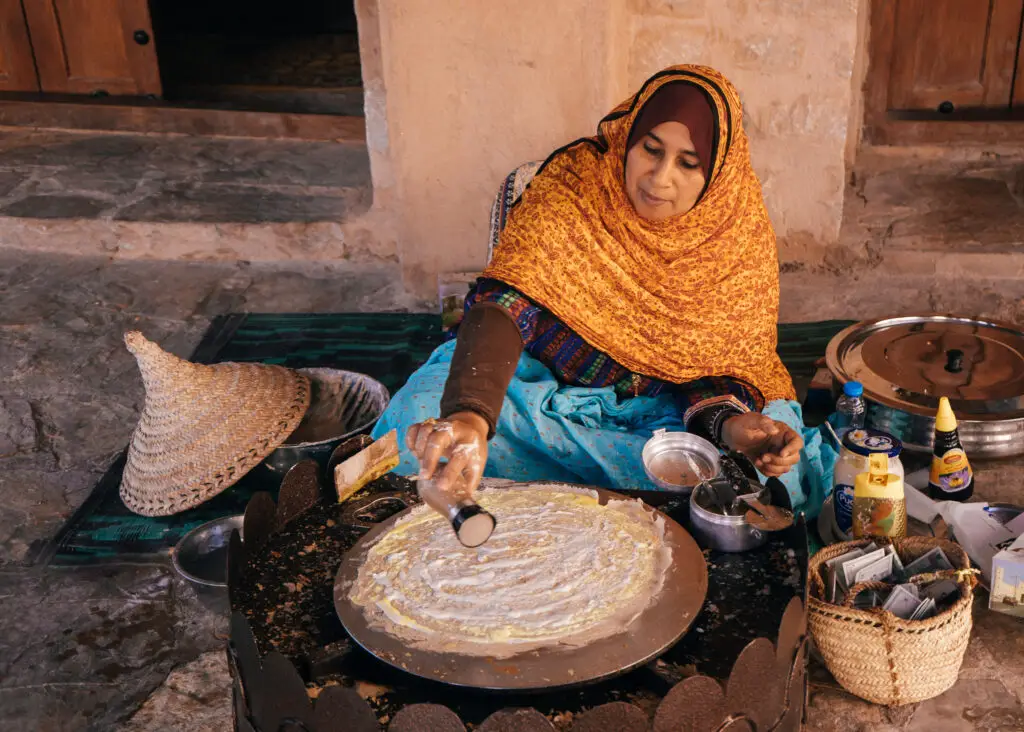 an omani woman making omani bread in nizwa 