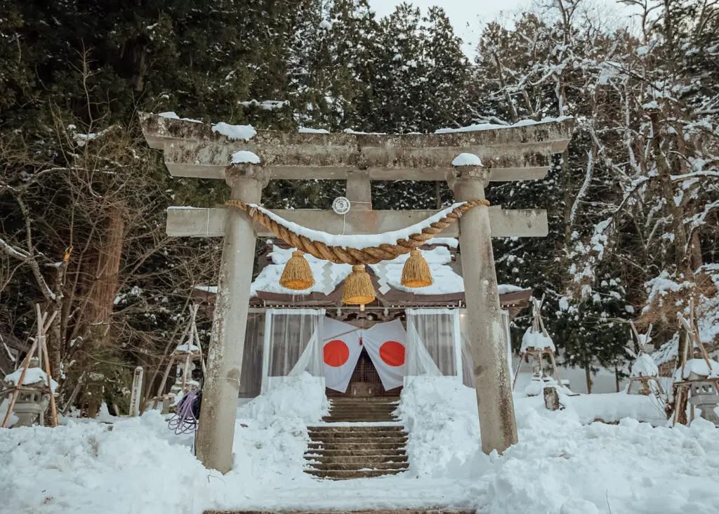 a temple in the snow at shirakawa-go in winter