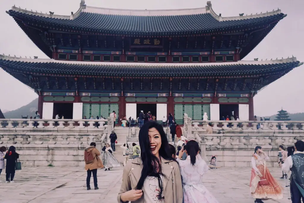 a girl in from of a palace in seoul