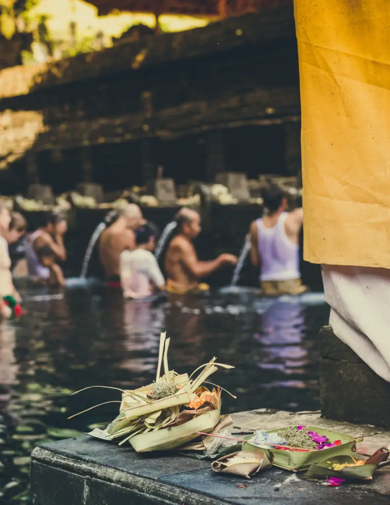 people bathing in tirta empul  temple in bali 