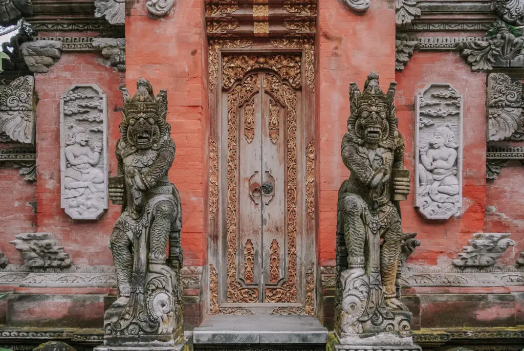 Is bali overrated? Ubud is a tourist hotspot but still worth visiting, especially for nature and to visit the temples like the one pictures, which is pink and features balinese stone statues