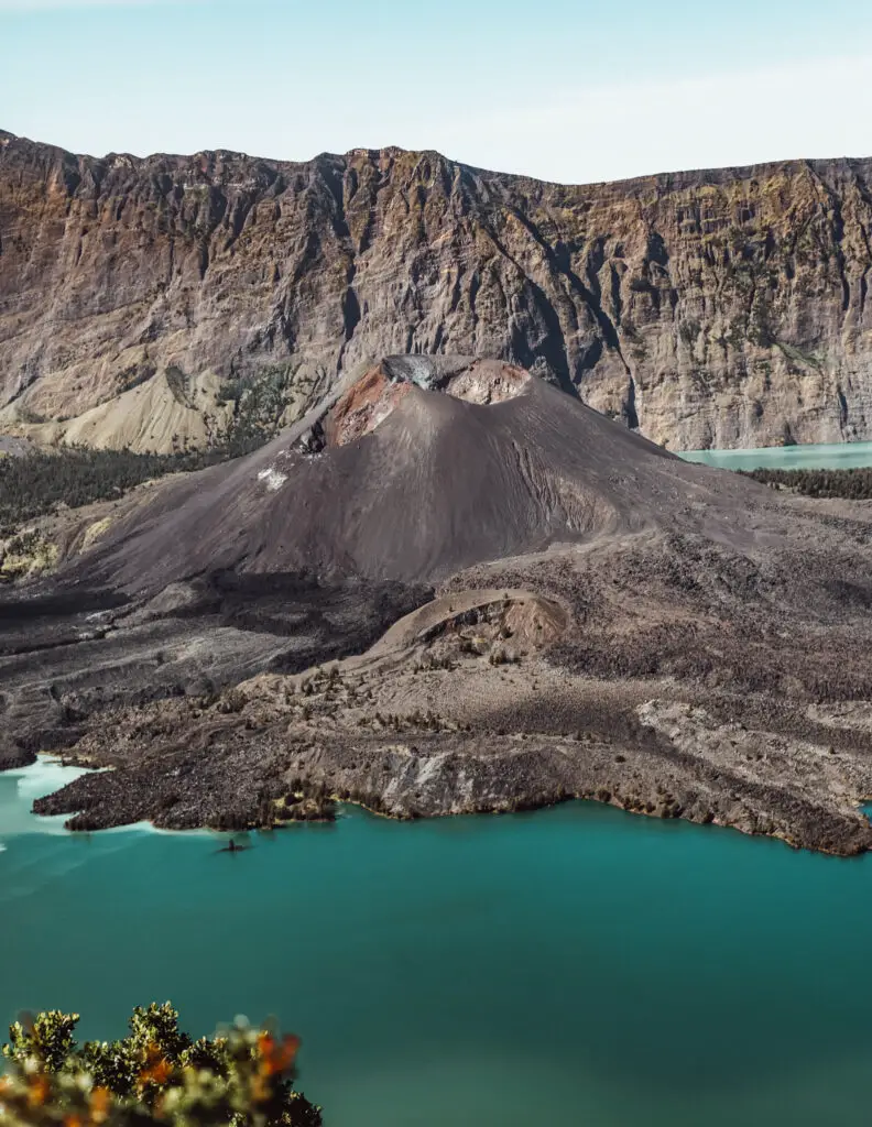 mount rinjani and its blue crater lake with a volcanic dome in the lake, on a sunny day