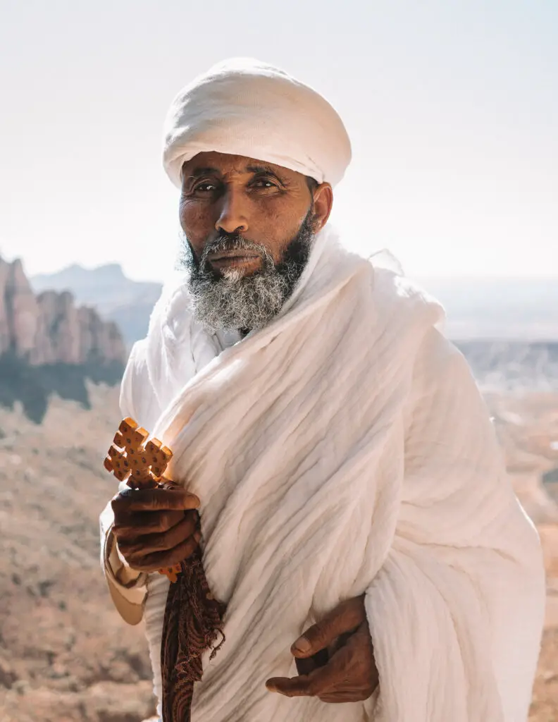 a priest holding a cross in the tigray region of ethiopia