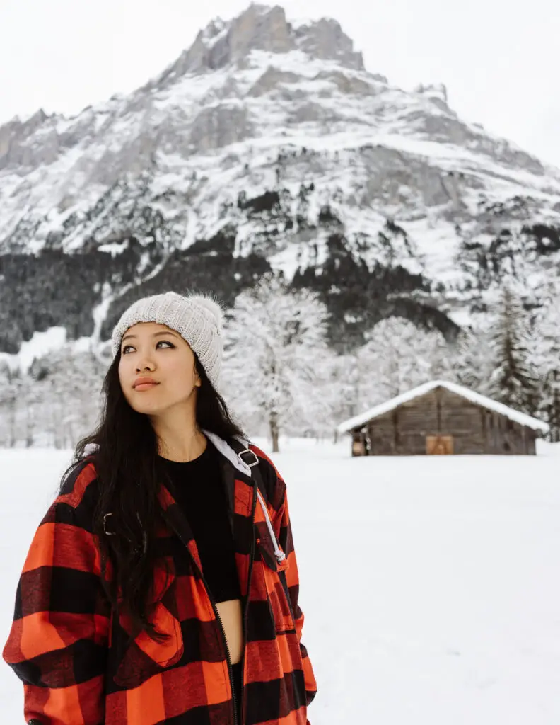 a girl visiting grindelwald switzerland in winter