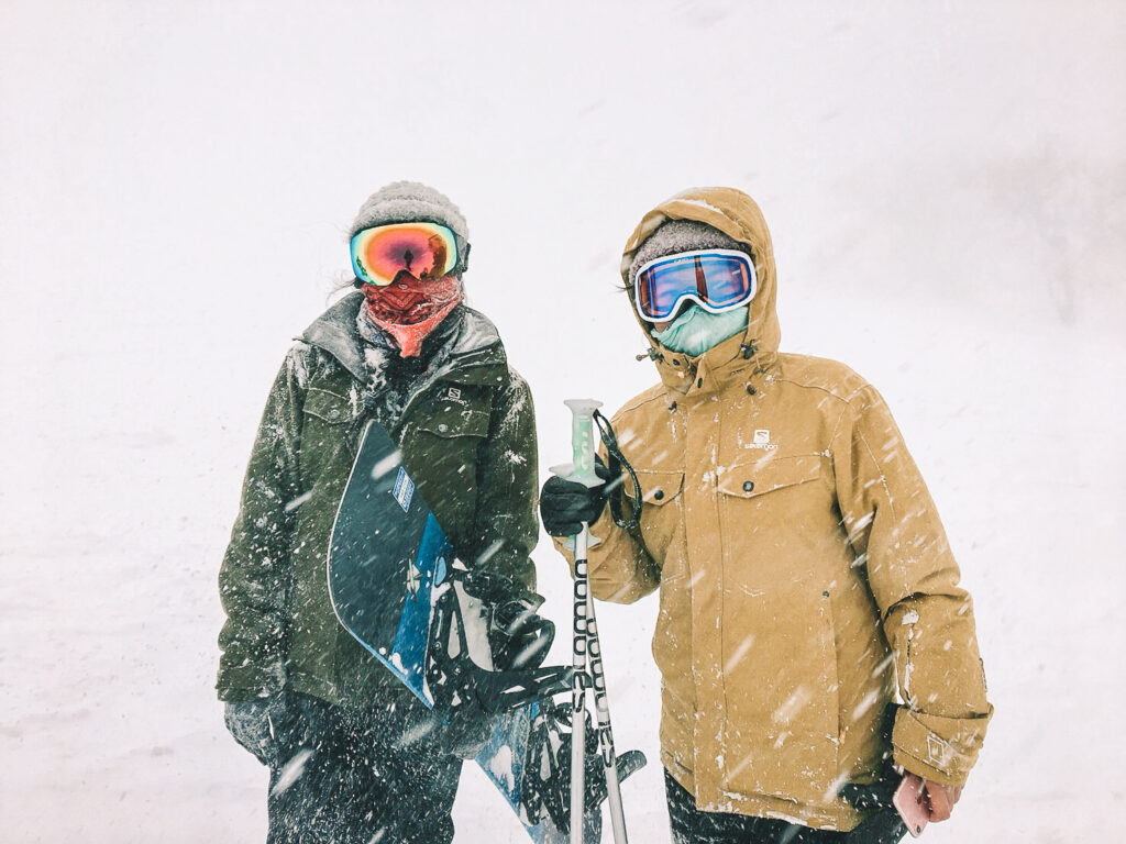 two snowboarders in the snow in japan at nozawa ski resort