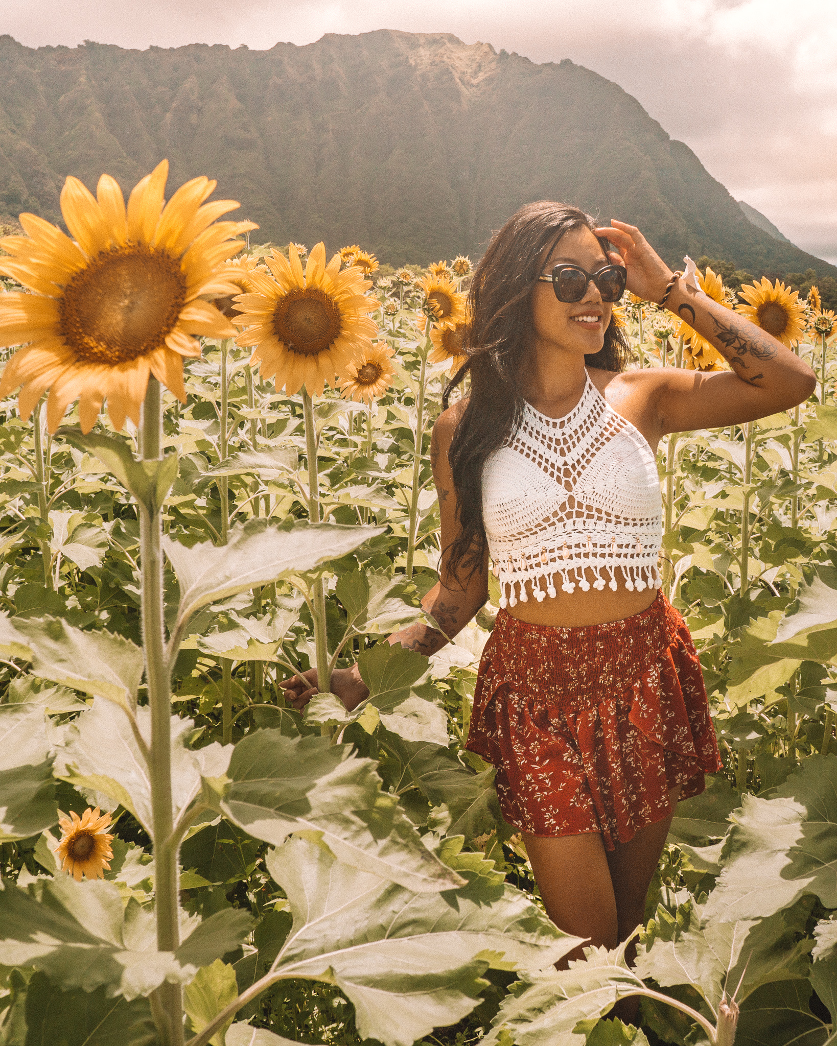 a girl at the waimanalo sunflower farm in hawaii