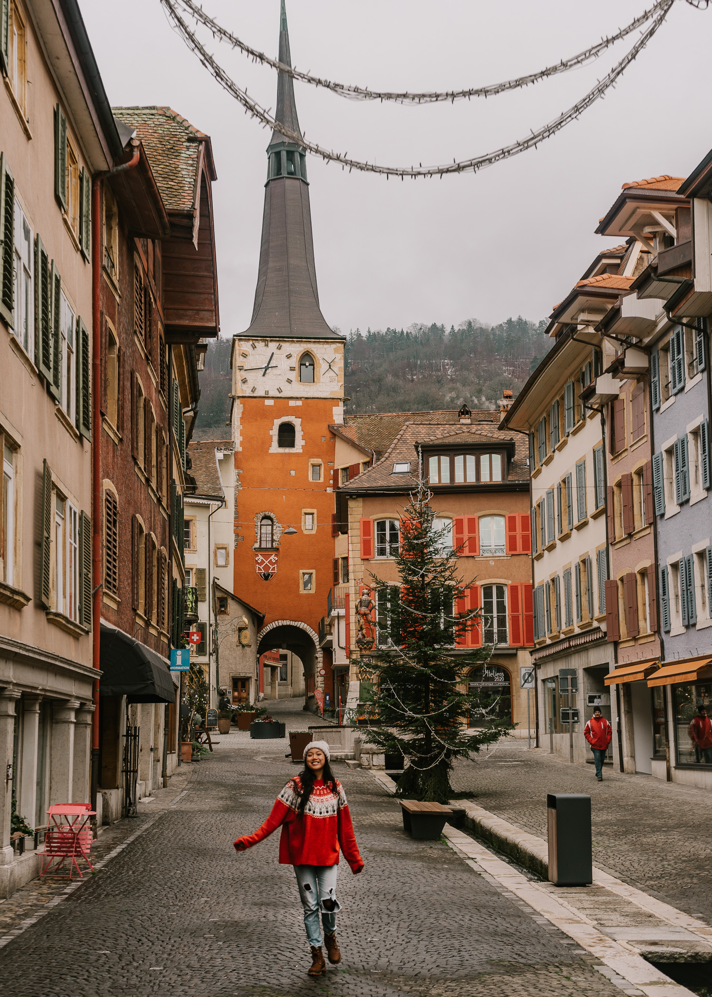 La Nueveville village from the main street with a large orange clock tower, one of the most beautiful villages in Switzerland in winter