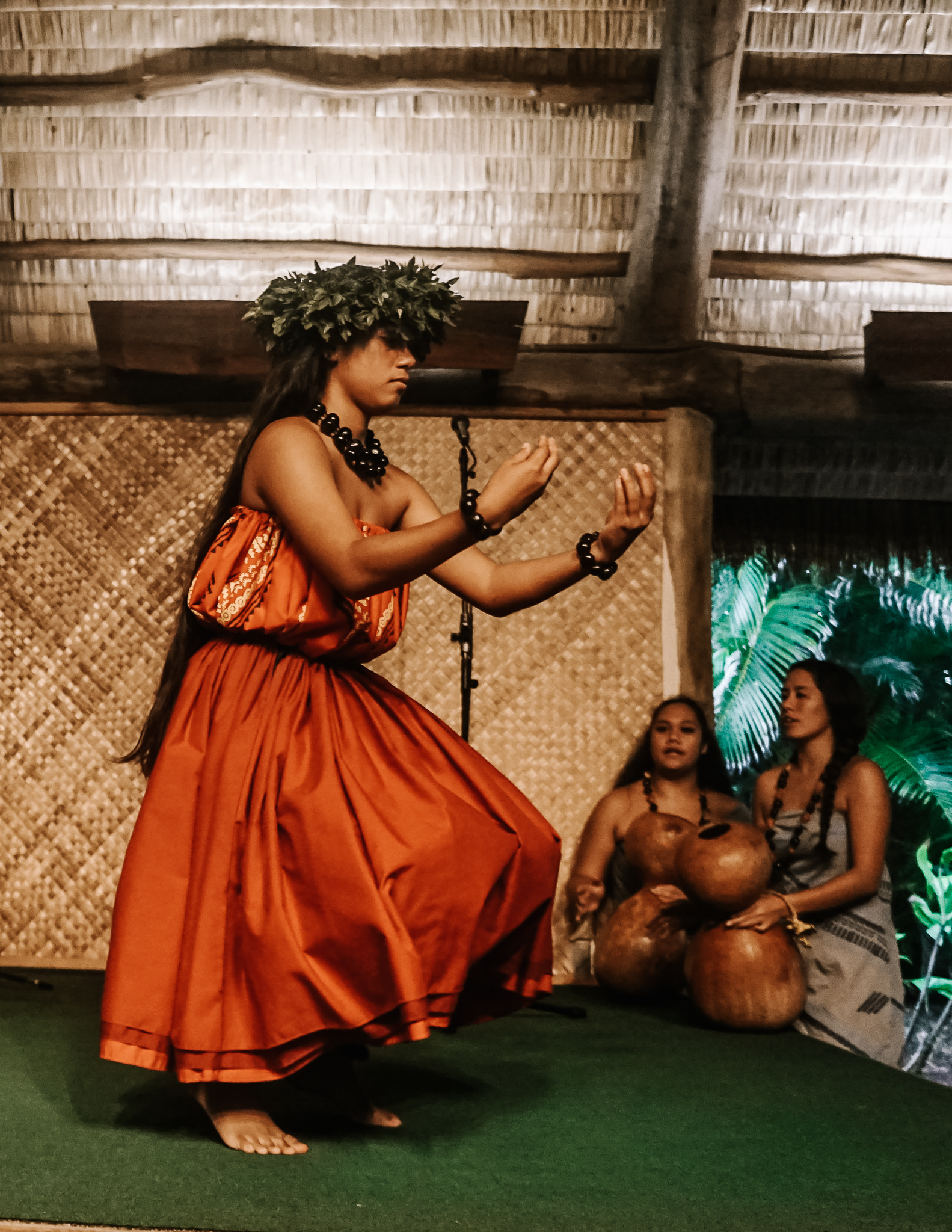 A hawaiian girl dancing a traditional dance at the polynesian cultural center