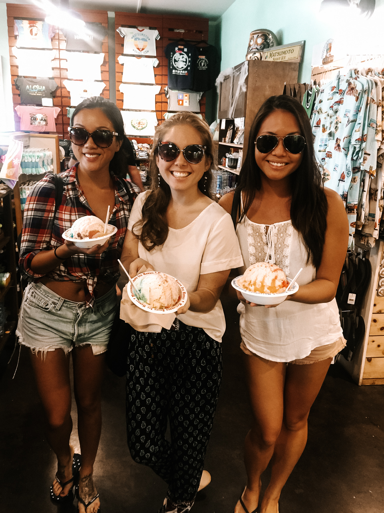 three girls in hawaii eating shave ice