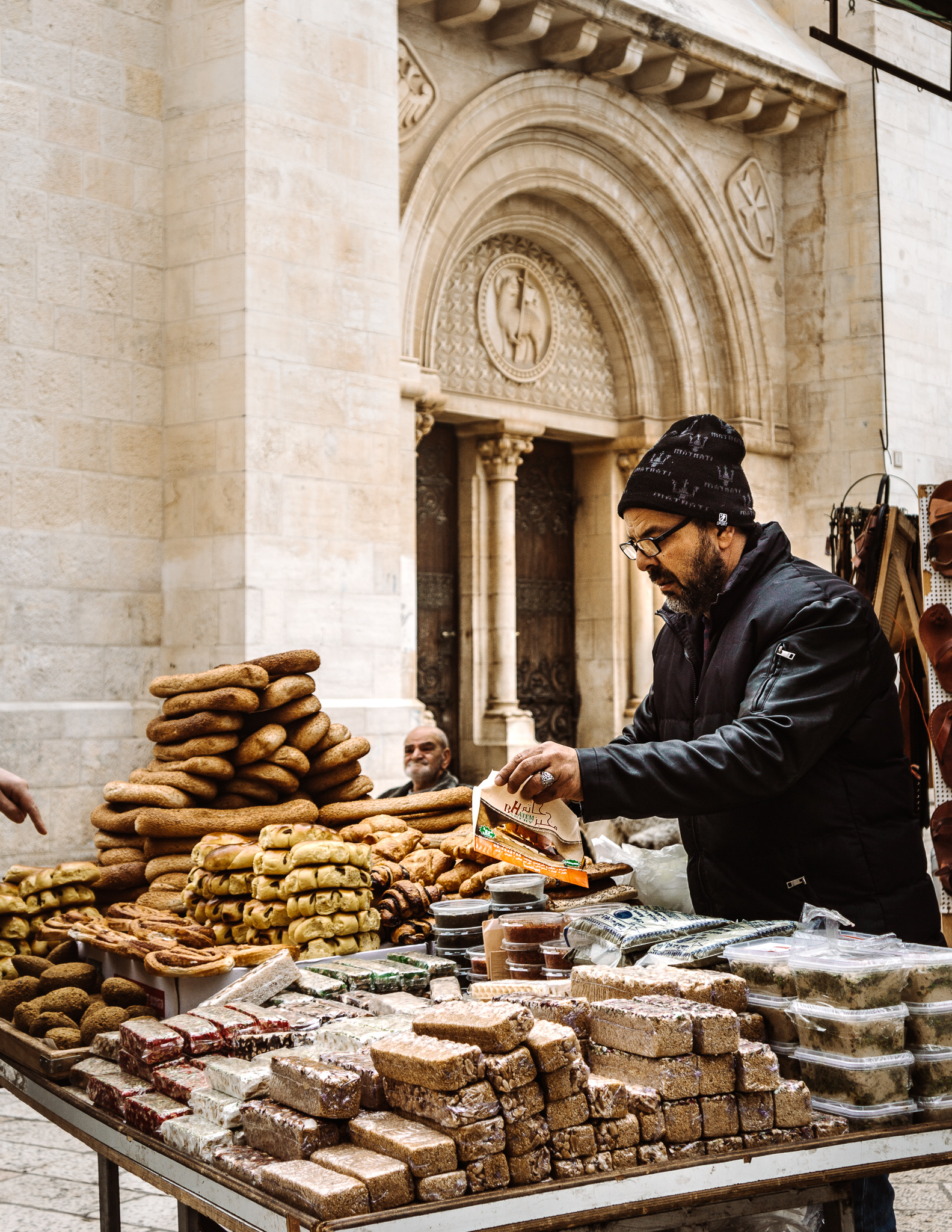 A man and a food cart selling Israeli sweets in the streets of Jerusalem