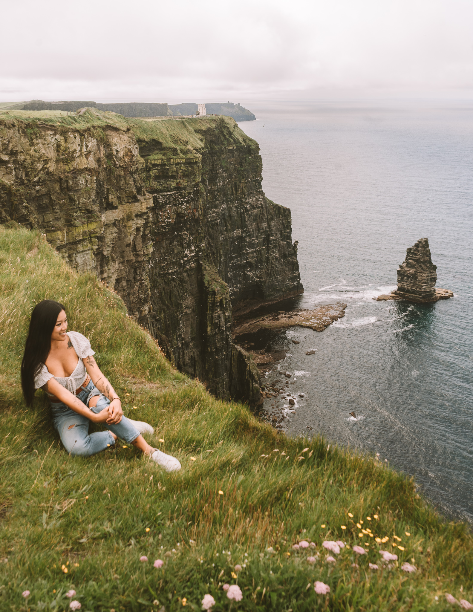 a digital nomad at the cliffs of moher in ireland
