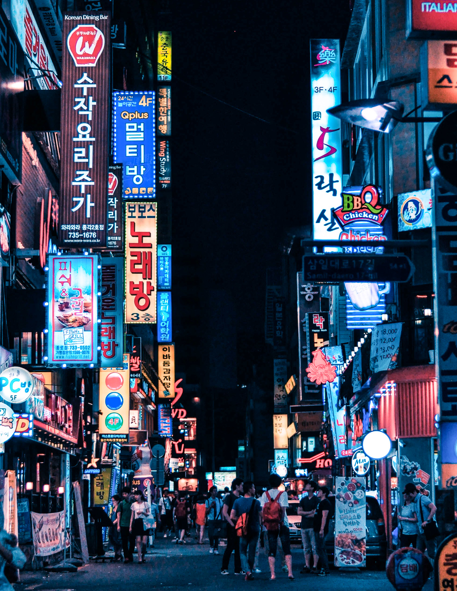 a view of a shopping street in seoul at night
