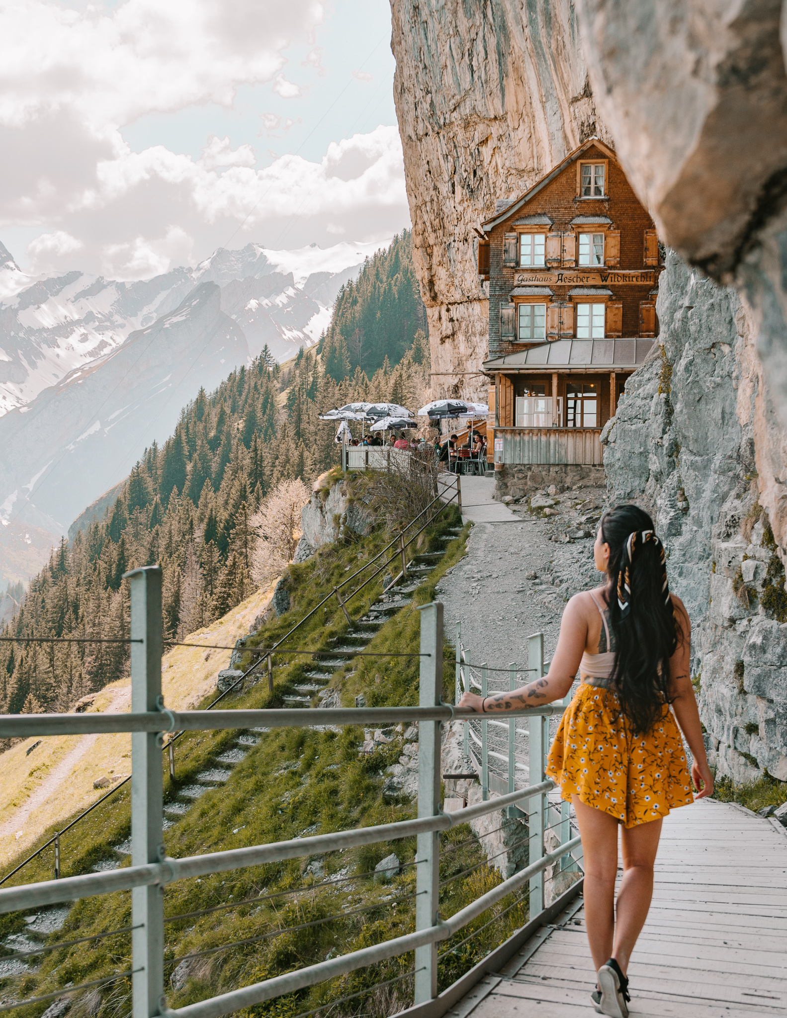 A girl on the walking path in front of the Aescher Guesthouse in switzerland