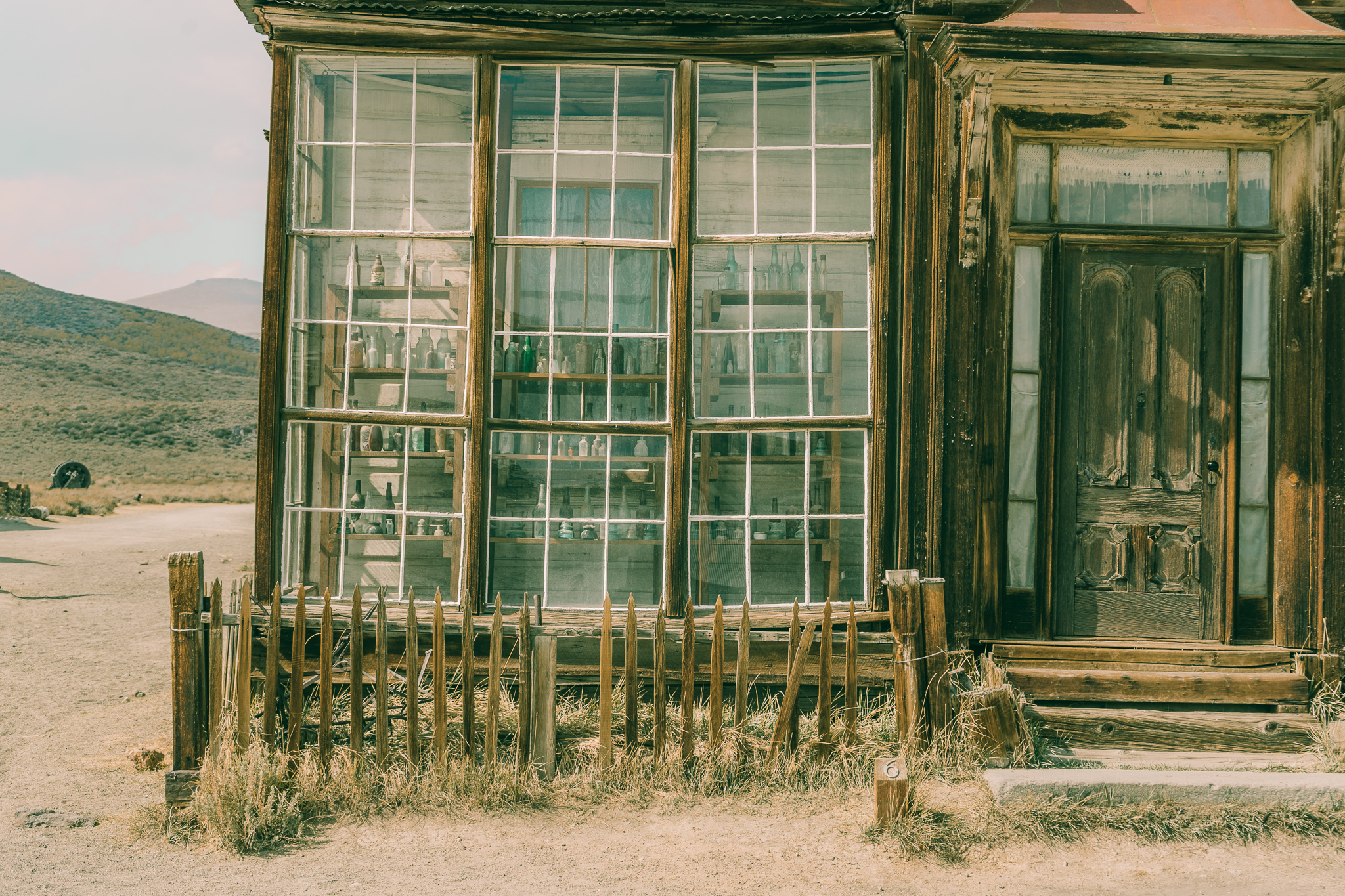 the J S Cain House window with bottles in Bodie