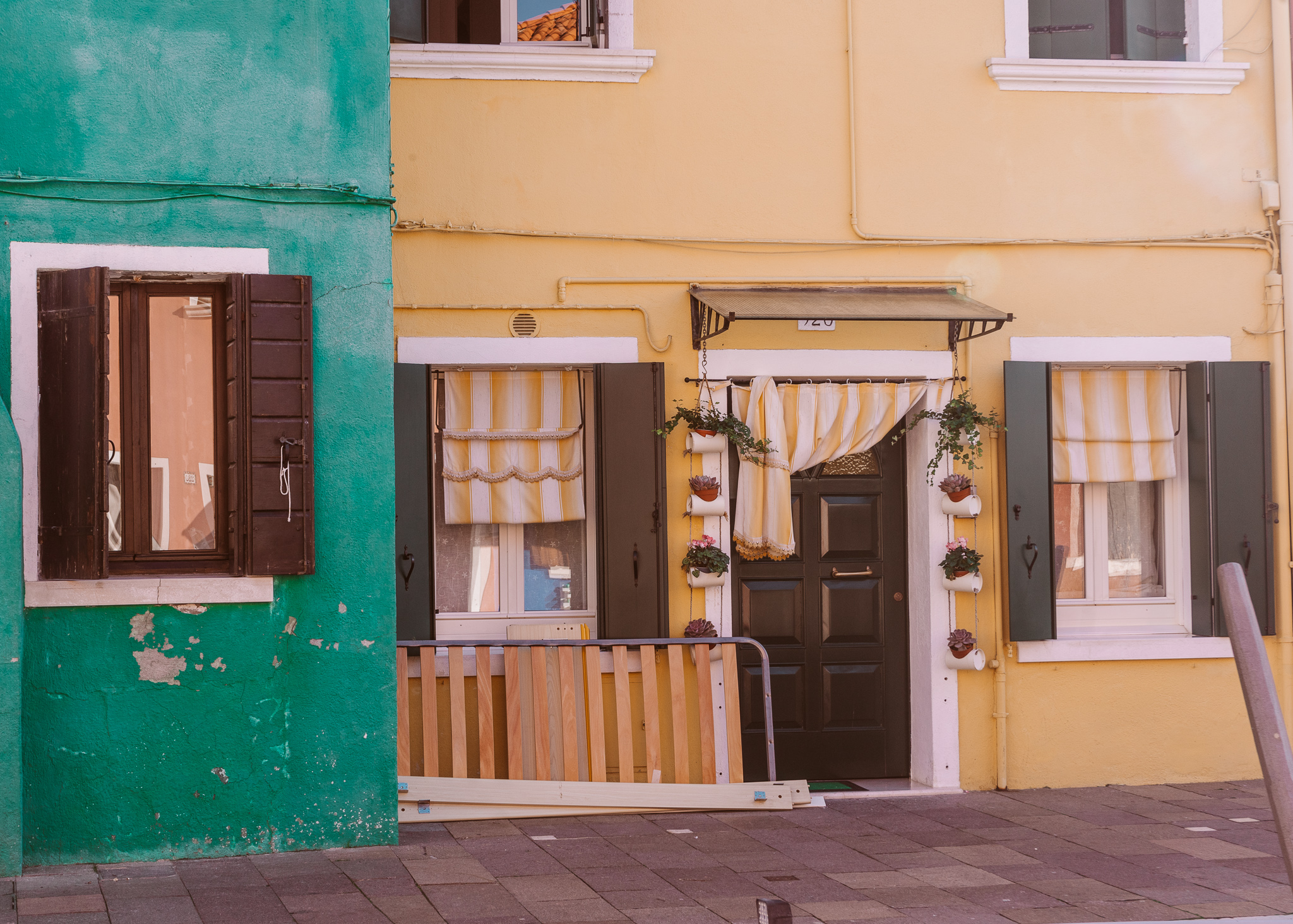 colorful green and yellow fisherman houses in Burano near Venice