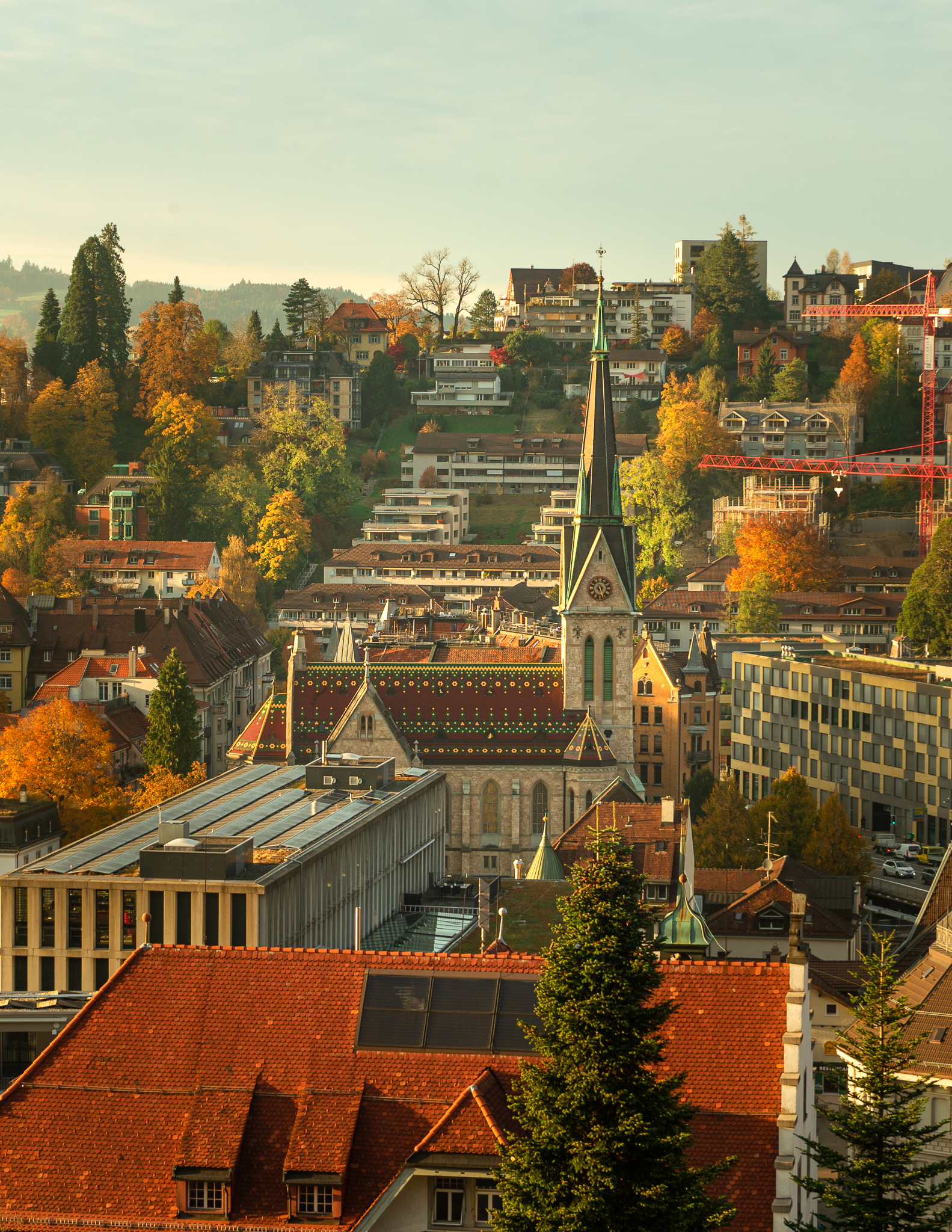 a view of St. Gallen church in autumn, with autumn leaves and colors in the background