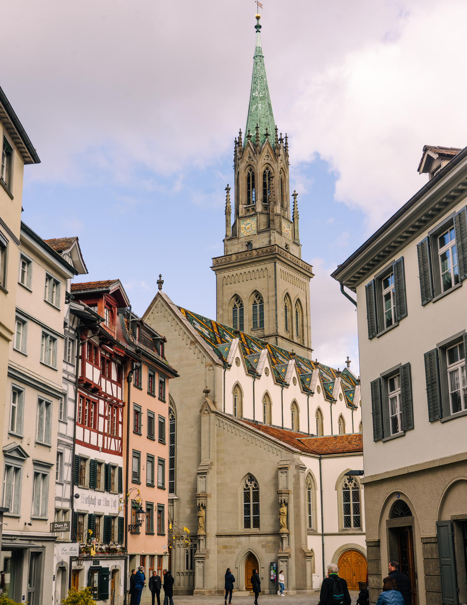 A view of the spire and colorfully tiled roof of St. Lawrence church in winter