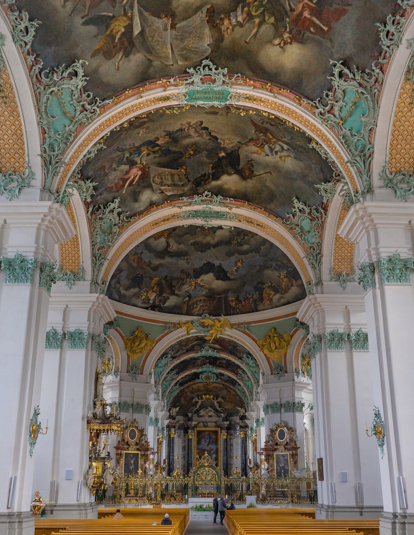 inside St. Gallen cathedral, featuring colorful frescos and carvings