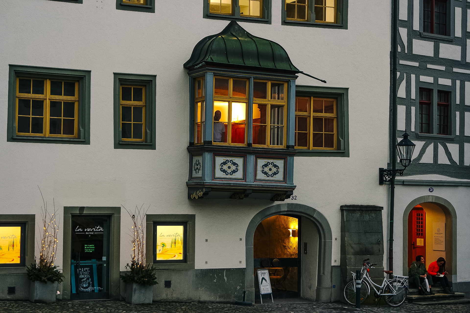 picture of a window in st. gallen, with painted facade and lit up from the inside