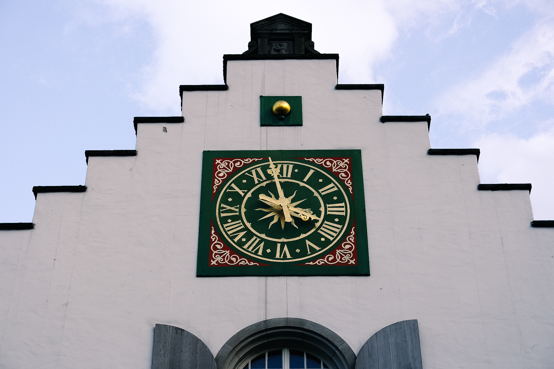 picture of a clock on a building facade in the old town of st. gallen