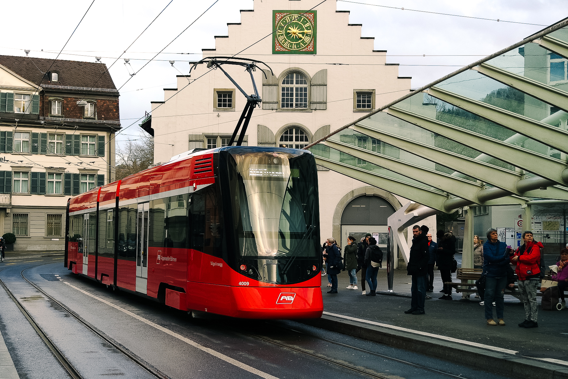 picture of a tram and a bus stop in the old town of st. gallen in winter