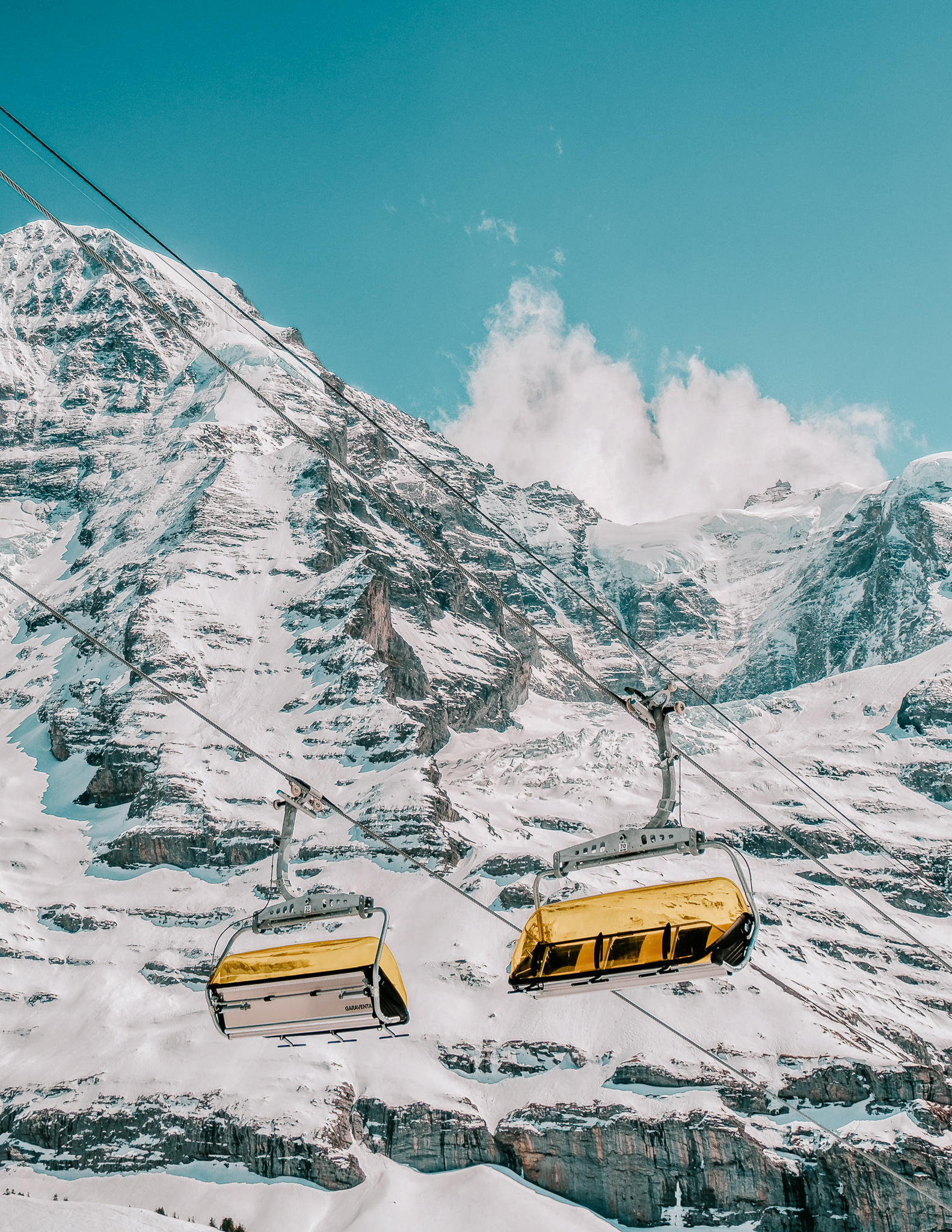 two yellow ski lifts in the Swiss alps in the Jungfrau region