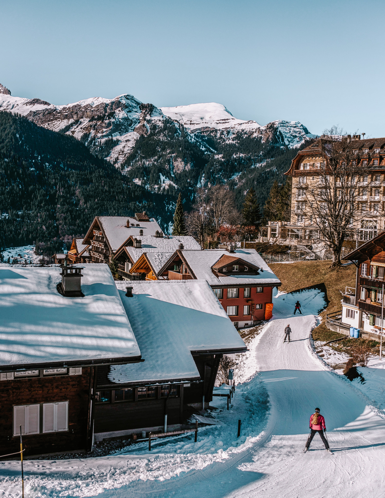 People cross-country skiing in a village near Lauterbrunnen in winter