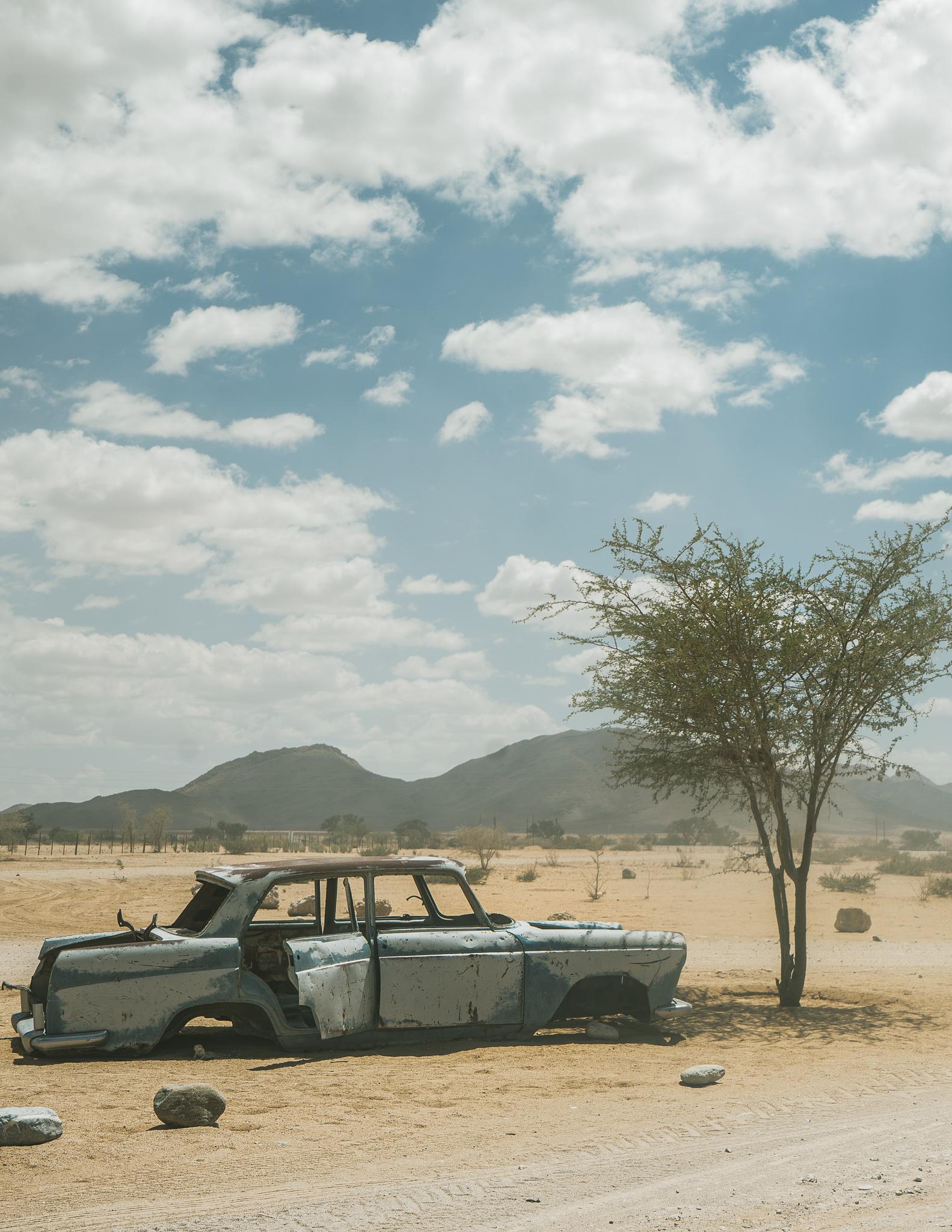 an abandoned car in the desert