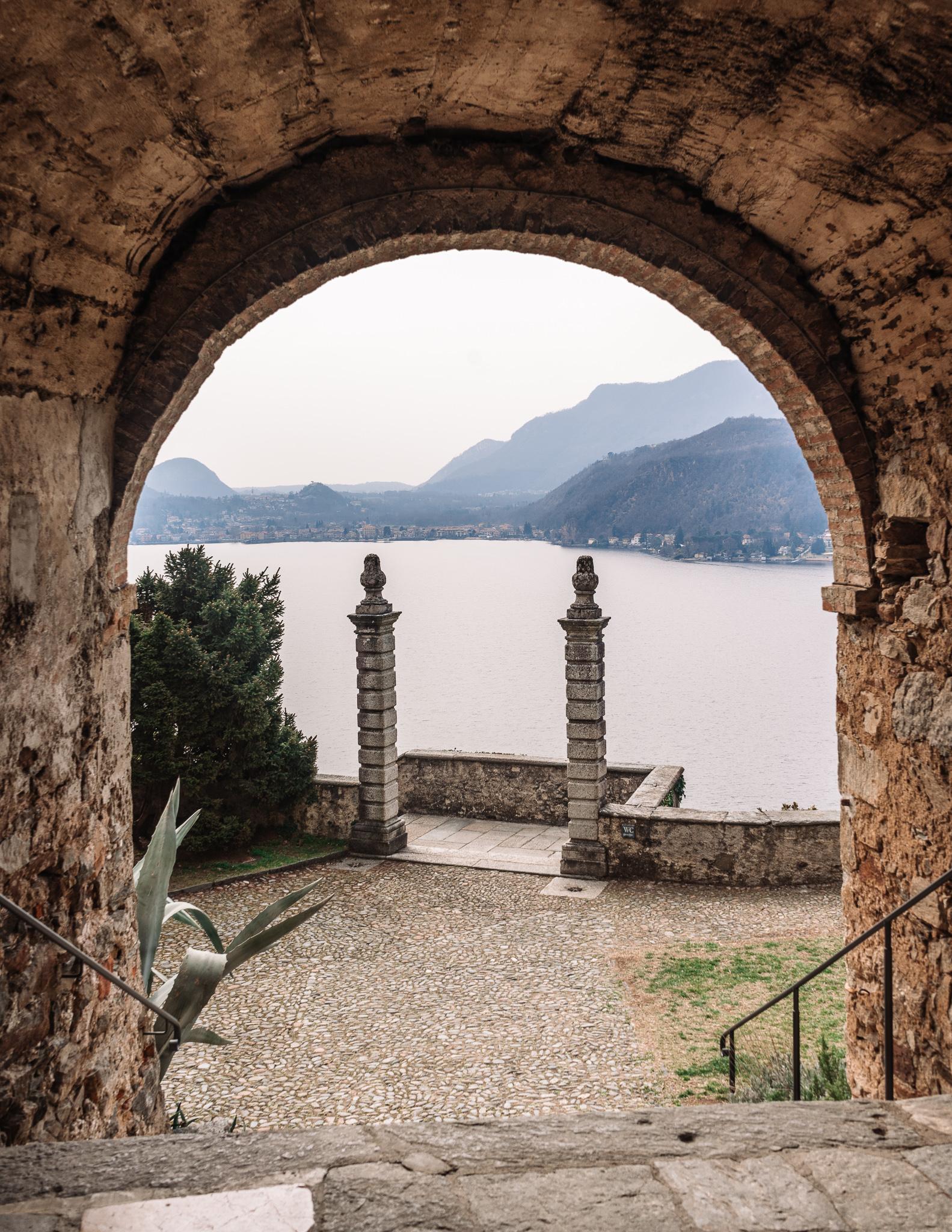 Archway with view of Lake Lugano beyond in Morcote, Ticino Switzerland