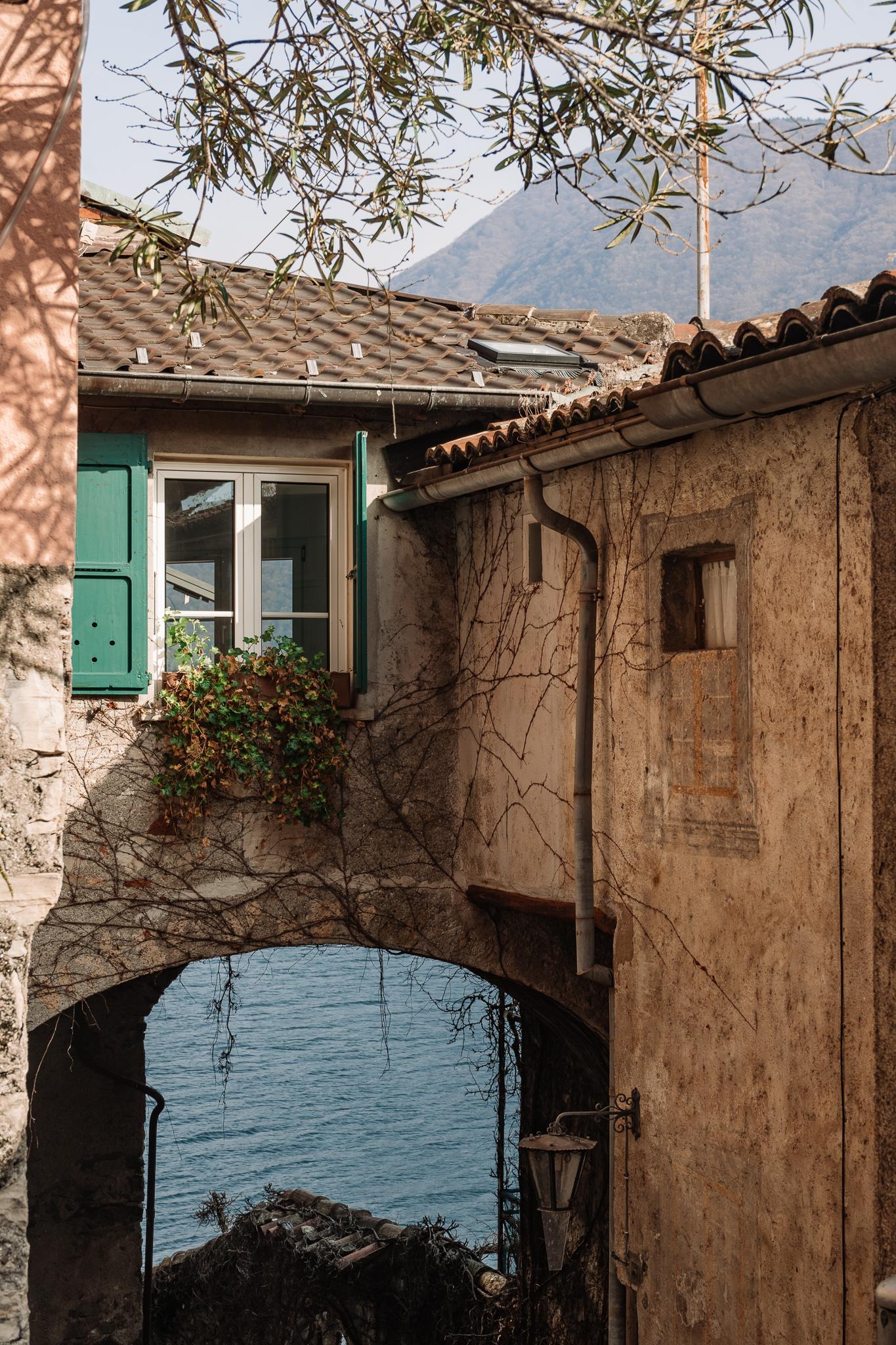 An old arch in Gandria, Ticino Switzerland with the lake behind