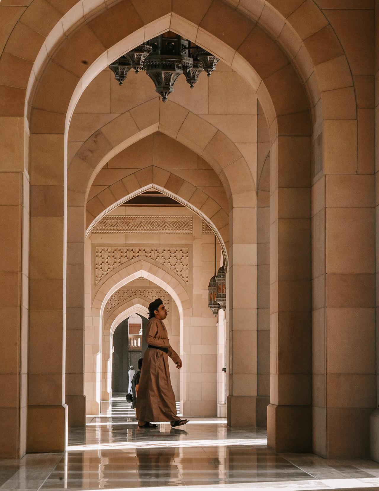 arches and a man in the grand mosque of Muscat, Oman