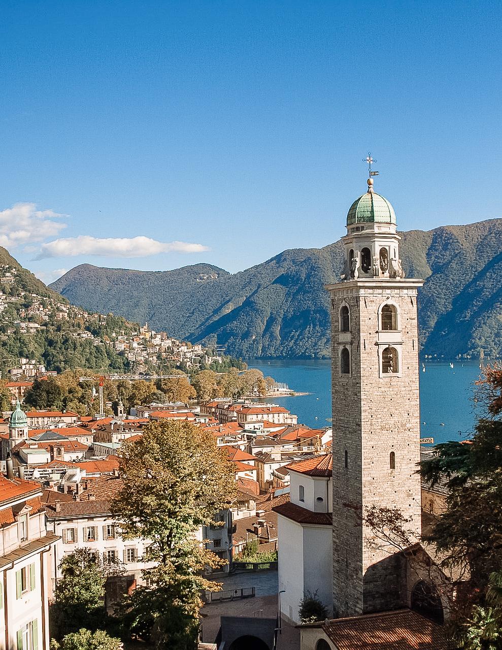 view of Lugano from above with the church tower and lake in view