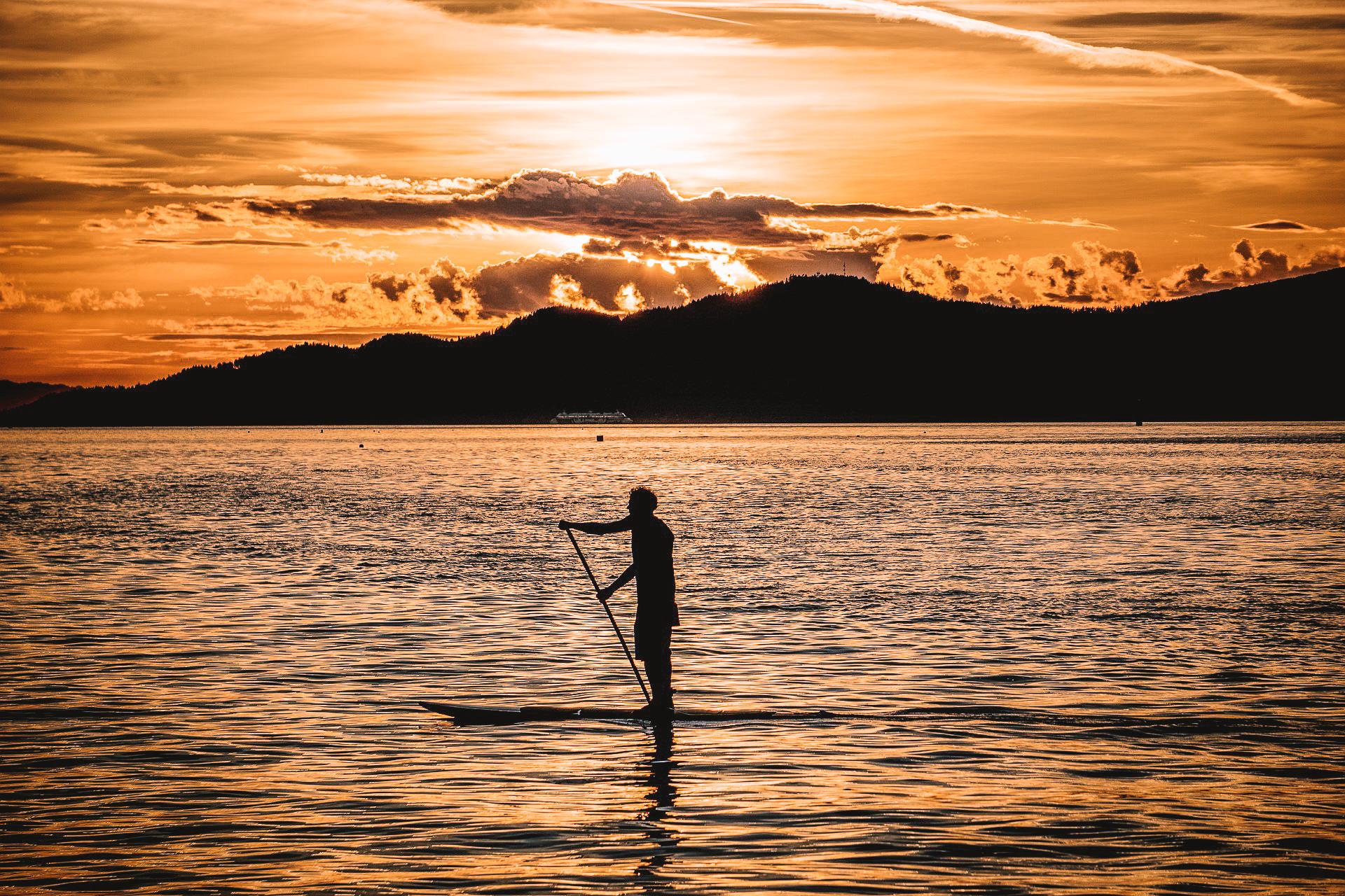 A man paddleboards on Laugarvatn Lake in Iceland