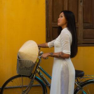 vietnamese woman biking in hoi an vietnam